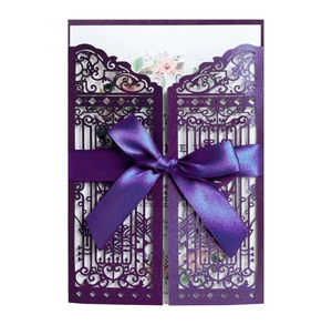 Detail of laser-cut purple invitation gate with satin ribbon and floral inner card