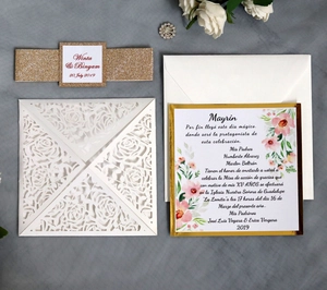 Detail of laser-cut rose invitation with gold glitter band and floral inner card