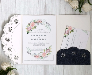 Close-up of laser-cut rose hollow invitation with glitter RSVP card and floral details