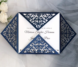 Detail of laser-cut navy wedding invitation with elegant white card and lace floral pattern