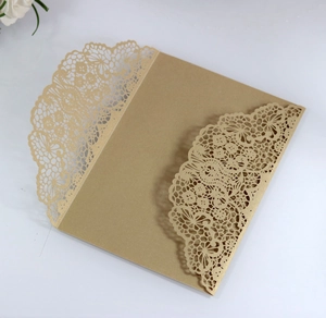 Macro detail of laser-cut lace pattern on golden pearlescent wedding invitation cover