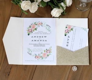 Elegant laser cut wedding invitation set with gold glitter pocket on wooden background