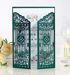 Detail of laser-cut gatefold wedding invitation in dark green with floral inner card