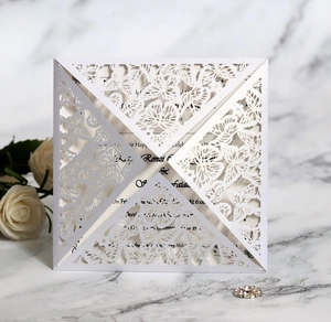 Detailed laser-cut butterfly wedding invitation with pearlescent white paper texture