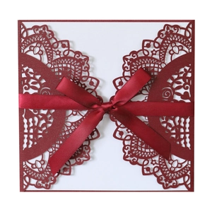 Elegant wine red laser-cut wedding invitation card with ribbon bow decoration