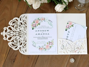 Detail of laser cut ivory floral lace invitation card with elegant floral wreath