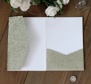 Champagne gold glitter laser cut invitation suite on wood with white roses