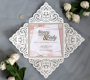 Laser cut white wedding invitation set with pink marble card and elegant gold accents
