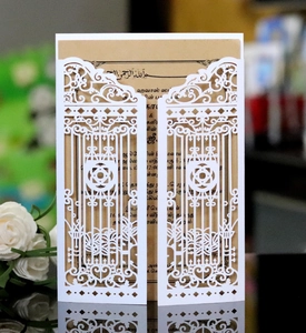Detail of laser-cut gate design wedding invitation with white cover and brown insert card