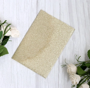 Elegant gold glitter rectangular wedding invitation card on white wood background