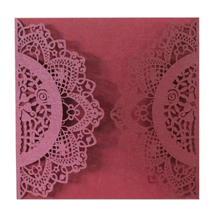 Detail of burgundy laser-cut lace mandala invitation on sparkling pearlescent paper