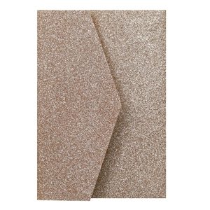Macro detail of rose gold glitter envelope with sparkling texture and V-flap design