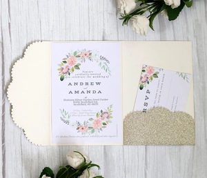 Close-up of elegant laser-cut scalloped wedding invitation with gold glitter pocket details