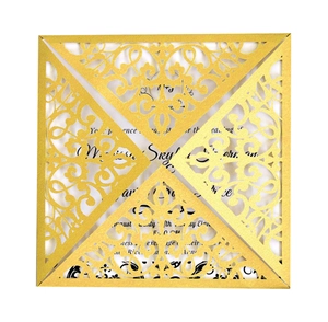 Detailed laser-cut hollow floral pattern on a gold wedding invitation with white insert card
