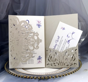 Detail of laser-cut rose invitation card in champagne gold with elegant RSVP insert