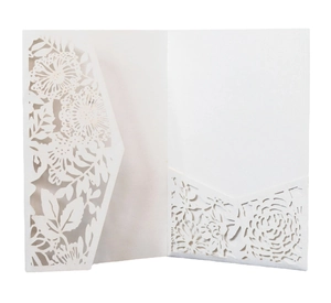 Elegant white laser-cut wedding invitation pocket with intricate floral hollow-out patterns