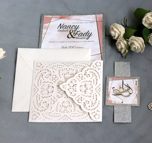 Detailed laser-cut pearl paper wedding invitation set with marble pattern and silver glitter band