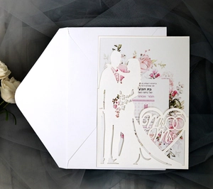 Laser-cut wedding invitation featuring a silhouette of a couple and a floral inner card