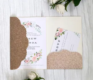 Detail of laser cut gold glitter wedding invitation with elegant pink floral watercolor cards