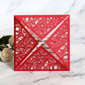 Close-up of red laser-cut butterfly wedding invitation with elegant marble background