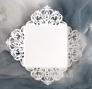Elegant white laser-cut lace wedding invitation cards with intricate hollow floral patterns