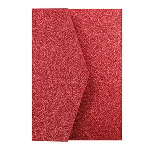 Macro shot of glittery red wedding envelope with sparkling texture and flap detail