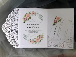 Elegant laser cut ivory wedding invitation set with watercolor floral inner cards and lace