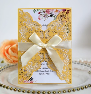 Elegant laser cut yellow wedding invitation with lace pattern and white ribbon bow