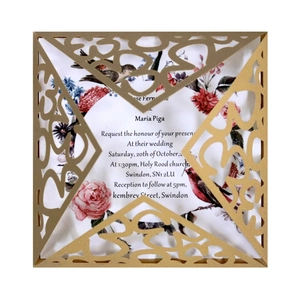Golden laser-cut wedding invitation set with floral inner card and hollow bird design