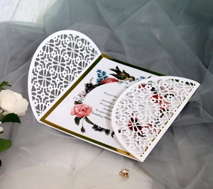 Elegant laser-cut wedding invitation with rose floral inner card on soft tulle background