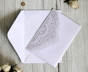 Elegant laser-cut lace wedding invitation with white envelope and pearlescent finish