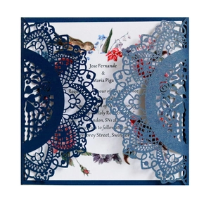 Detail of laser-cut navy blue wedding invitation with floral inner card and mandala pattern