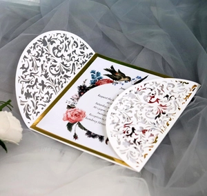 Elegant white laser-cut invitation card set with gold border and floral patterns
