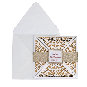 Detailed laser cut lace wedding invitation with champagne gold glitter belly band and envelope
