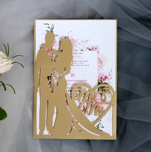 Detail of laser-cut gold wedding invitation with Mr & Mrs silhouette and floral insert