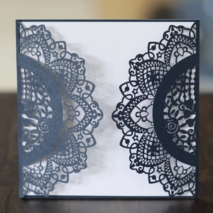 Navy blue laser cut wedding invitation with elegant mandala lace pattern and white insert