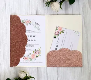 Detail of rose gold glitter laser-cut wedding invitation with elegant floral inserts