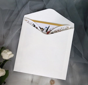 Detail of laser cut wedding invitation with colorful floral and bird illustration
