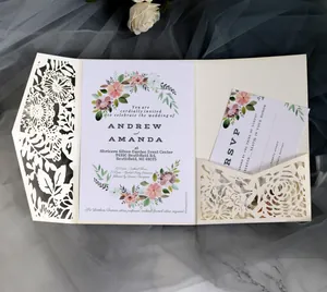 Detailed laser cut ivory wedding invitation suite with floral cards and matching envelopes