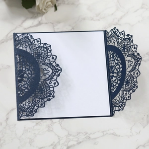 Detail of laser-cut mandala floral pattern on dark blue pearlescent invitation card