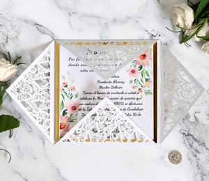 Detail of laser-cut butterfly wedding invitation with gold lining and Spanish text