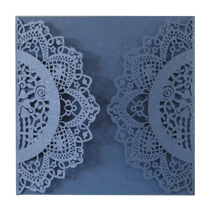 Detailed laser-cut navy blue wedding invitation card with intricate lace floral texture