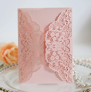 Detail showing pink laser-cut floral lace wedding invitation card with pearlescent finish