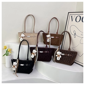 Detail view of large faux suede leopard print tote bags in five different colors
