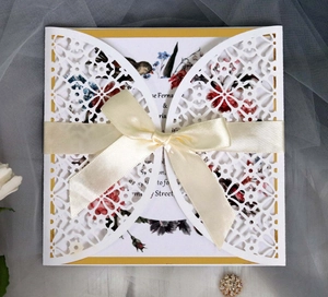 Elegant laser cut wedding invitation with vintage floral pattern and satin ribbon bow
