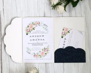 Detailed view of laser-cut ivory wedding invitation set with navy glitter and floral cards
