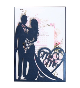 Macro view of laser-cut navy blue wedding invitation with Mr & Mrs heart pattern