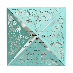 Mint green laser cut wedding invitation with intricate floral lace and pearl paper
