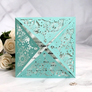 Laser cut lace wedding invitation in pearl blue paper with elegant floral patterns