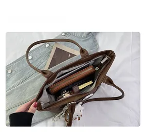 Top view showing the spacious interior of a brown suede tote with organized compartments